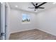 Bright and airy bedroom with light wood-style laminate flooring and a sunny window at 1930 W Missouri Ave, Phoenix, AZ 85015