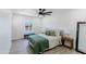 Cozy bedroom with a queen-sized bed, bright window, and wood-style laminate flooring at 1930 W Missouri Ave, Phoenix, AZ 85015