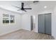 Spacious bedroom featuring a window, a ceiling fan, and a convenient sliding door closet at 1930 W Missouri Ave, Phoenix, AZ 85015