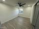 A well-lit bedroom with wood floors, ceiling fan, a window, and neutral walls at 1930 W Missouri Ave, Phoenix, AZ 85015