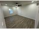 Spacious bedroom featuring wood floors, a ceiling fan, bright window, and neutral walls at 1930 W Missouri Ave, Phoenix, AZ 85015