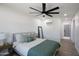 Bright bedroom boasts a comfortable queen bed, a ceiling fan, and lots of light at 1930 W Missouri Ave, Phoenix, AZ 85015