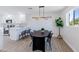 Elegant dining room with contemporary lighting, sleek table set, and modern white kitchen at 1930 W Missouri Ave, Phoenix, AZ 85015