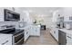 Bright kitchen featuring white cabinets, modern appliances, and seamless flow to the dining area at 1930 W Missouri Ave, Phoenix, AZ 85015