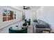 Bright living room featuring light wood floors, a large window, and stylish gray sofa at 1930 W Missouri Ave, Phoenix, AZ 85015