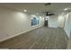 Bright and airy living room with modern flooring, white walls, and large windows at 1930 W Missouri Ave, Phoenix, AZ 85015