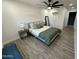 Comfortable bedroom with modern décor, stylish lighting, and wood-look floors at 1930 W Missouri Ave, Phoenix, AZ 85015