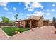 Spacious backyard with artificial turf, desert landscaping, patio with orange curtains, and a privacy fence at 19648 N 8Th Pl, Phoenix, AZ 85024