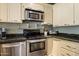 Cozy kitchen with stainless steel appliances and granite countertops, offering a blend of functionality and style at 19648 N 8Th Pl, Phoenix, AZ 85024