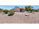 Expansive backyard with desert landscaping and covered patio at 19662 N Overton Ct, Surprise, AZ 85374
