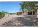 Spacious backyard featuring desert landscaping, covered patio, and neutral exterior at 19662 N Overton Ct, Surprise, AZ 85374