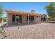 Charming covered patio area with desert landscaping, ideal for relaxing at 19662 N Overton Ct, Surprise, AZ 85374