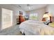 Bedroom with neutral tones, ceiling fan, plush carpet, and an adjoining bathroom at 19662 N Overton Ct, Surprise, AZ 85374