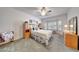 Cozy bedroom with a large bed, wood furnishings, bay window, and shutter blinds at 19662 N Overton Ct, Surprise, AZ 85374