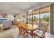 Bright dining area featuring a wood table, chandelier, and access to the outdoor patio through sliding glass doors at 19662 N Overton Ct, Surprise, AZ 85374