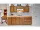Kitchen featuring wood cabinets, light countertops, tile backsplash, and modern appliances at 19662 N Overton Ct, Surprise, AZ 85374