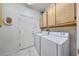 Laundry room with a washer, a dryer, and storage cabinets at 19662 N Overton Ct, Surprise, AZ 85374