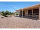 Relaxing covered patio area with desert landscaping, perfect for outdoor enjoyment at 19662 N Overton Ct, Surprise, AZ 85374