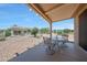 Cozy covered patio with outdoor seating, offering a serene backyard view at 19662 N Overton Ct, Surprise, AZ 85374