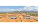 An aerial view of new construction homes nestled in the desert landscape with mountains in the background on a sunny day at 1969 E Long Rifle Rd, Phoenix, AZ 85086
