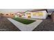 Well-maintained backyard with artificial turf, hardscape, and stone landscaping at 21120 E Superstition Dr, Queen Creek, AZ 85142