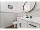 Powder room with beadboard paneling, modern vanity, and a round mirror at 21120 E Superstition Dr, Queen Creek, AZ 85142