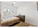 Bedroom featuring a bed, ceiling fan, wood flooring, and a chest of drawers at 21120 E Superstition Dr, Queen Creek, AZ 85142