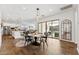 Bright dining room with wood-look tile, modern light fixtures, and sliding glass doors to backyard at 21120 E Superstition Dr, Queen Creek, AZ 85142