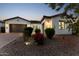 Beautiful home exterior showcasing a stone driveway, desert landscaping, and a two-car garage at 21120 E Superstition Dr, Queen Creek, AZ 85142