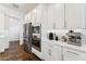 Modern kitchen with white cabinets, stainless steel appliances, and a sleek countertop design at 21120 E Superstition Dr, Queen Creek, AZ 85142