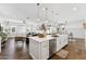 Open-concept kitchen with a large island, stainless steel appliances, and seamless flow to the living area at 21120 E Superstition Dr, Queen Creek, AZ 85142