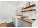 Bright laundry room with white cabinets, butcher block countertop, and modern washer and dryer at 21120 E Superstition Dr, Queen Creek, AZ 85142