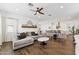 Open concept living room and kitchen with dark wood floors, modern lighting, and comfortable seating at 21120 E Superstition Dr, Queen Creek, AZ 85142
