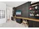 Stylish home office with custom shelving, cabinets, desk, and board and batten accent wall at 21120 E Superstition Dr, Queen Creek, AZ 85142