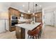 Elegant kitchen featuring an island with seating, stainless steel appliances, and ample cabinet space for storage at 23083 N 74Th Pl, Scottsdale, AZ 85255