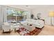 Cozy living room with a white sofa, patterned rug, and sliding glass doors that open to a private outdoor patio at 23083 N 74Th Pl, Scottsdale, AZ 85255