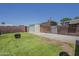 Large backyard with a fire pit, fenced perimeter, and convenient storage shed at 2432 W Echo Ln, Phoenix, AZ 85021
