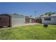 Spacious backyard with storage shed, fire pit, and secure fencing, providing privacy at 2432 W Echo Ln, Phoenix, AZ 85021
