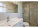 Modern bathroom with glass-enclosed shower, updated fixtures, a new toilet, and a large mirror at 2432 W Echo Ln, Phoenix, AZ 85021