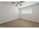 The bedroom includes a ceiling fan, tile floors, and a window for natural light at 2432 W Echo Ln, Phoenix, AZ 85021