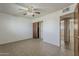 Neutral bedroom features tan tiled floors and access to a closet and hallway at 2432 W Echo Ln, Phoenix, AZ 85021
