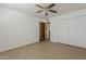 Bedroom featuring a ceiling fan, tile floors, closet, and a door to the adjacent room at 2432 W Echo Ln, Phoenix, AZ 85021