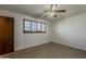 Bedroom with tile floors, a door, and a window with blinds at 2432 W Echo Ln, Phoenix, AZ 85021