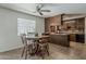 Inviting dining area with warm natural light, ceiling fan, and convenient kitchen access at 2432 W Echo Ln, Phoenix, AZ 85021