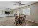 Bright dining area with tile floors, ceiling fan, and views of the built-in entertainment center at 2432 W Echo Ln, Phoenix, AZ 85021