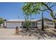 Charming single-story home with a well-manicured desert landscape, mature trees, and a two-car garage at 2432 W Echo Ln, Phoenix, AZ 85021