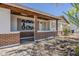 Charming covered porch area featuring brick accents, and desert landscaping with a rock ground cover at 2432 W Echo Ln, Phoenix, AZ 85021