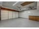 Spacious garage with epoxy floors, ample storage, and an automatic door opener at 2432 W Echo Ln, Phoenix, AZ 85021