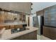 Open kitchen featuring dark cabinets, updated appliances, and convenient access to dining area at 2432 W Echo Ln, Phoenix, AZ 85021
