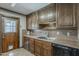 Traditional kitchen showcasing rich wood cabinetry, durable countertops, and a stainless steel sink at 2432 W Echo Ln, Phoenix, AZ 85021